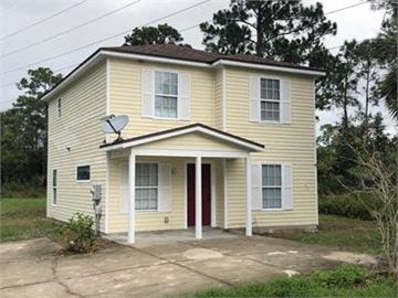 St Augustine house for rent - A yellow house with a red door and a satellite dish on the roof.
