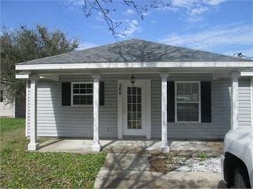 St Augustine house for rent - A small white house with a porch and a covered front door.