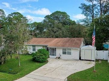 St Augustine house for rent - A house with a flag on a pole in front of it.