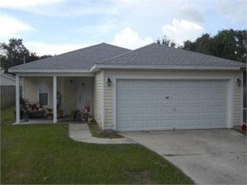 St Augustine house for rent - A house with a white garage door and a grey roof.