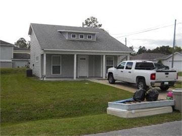 St Augustine house for rent - A white truck is parked in front of a house.