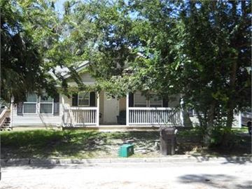 St Augustine house for rent - A house with a porch and a tree in front.