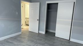 Fresno apartment for rent - A white door is open in a room with grey walls.