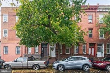 Philadelphia house for rent - A tree in front of a red brick building.