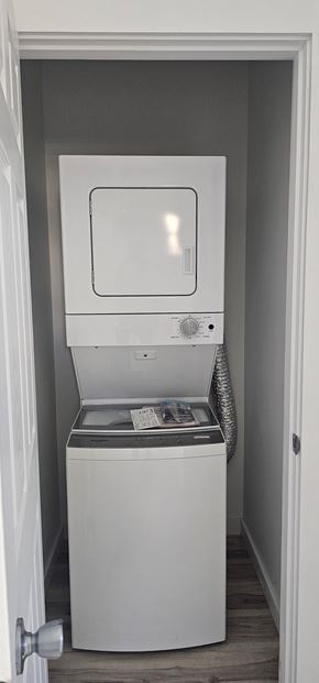 South Bend apartment for rent - A white dishwasher is in a small, white-walled space.
