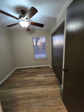 St. Louis house for rent - A room with a ceiling fan and wooden flooring.