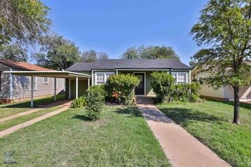 Abilene house for rent - A house with a green lawn and a clear blue sky.