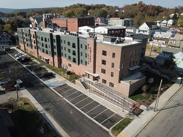 Brunswick apartment for rent - A parking lot is in front of a large brick building with the word "RASOROBRO" on it.