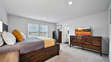 Katy house for rent - A bedroom with a bed, dresser, and a painting on the wall.
