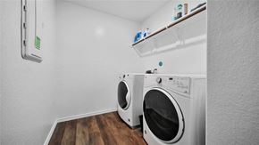 Katy house for rent - Two white front loading washing machines in a small laundry room.