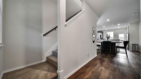 Katy house for rent - A modern interior with a staircase and a dining area.
