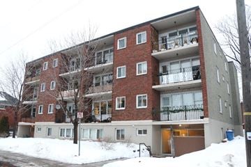 Ottawa apartment for rent - A red brick apartment building with a no parking sign in front.