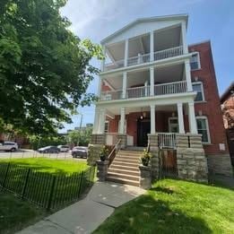 Ottawa apartment for rent - A red brick building with a white balcony.
