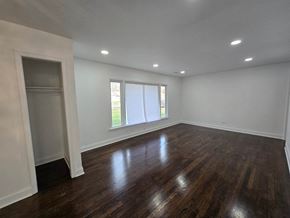 Gary house for rent - A room with wooden floors and a window with blinds.