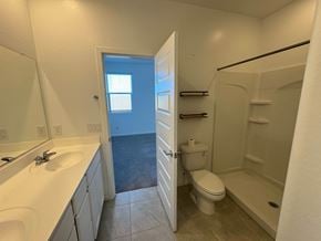 Tolleson house for rent - A bathroom with a toilet, sink, and bathtub.