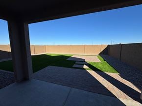 Tolleson house for rent - A patio with a brick walkway leads to a grassy area.