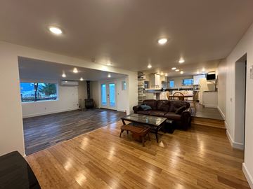 Sitka house for rent - A living room with a brown couch and a coffee table.