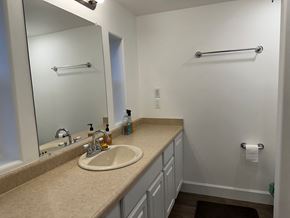 Sitka house for rent - A bathroom with a sink, mirror, and towel rack.