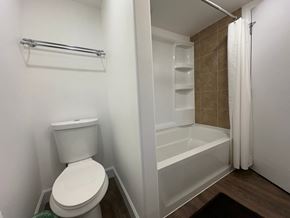 Sitka house for rent - A white toilet sits in a small bathroom next to a walk-in shower.