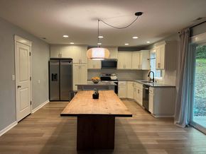 Kelso house for rent - A kitchen with a wooden table in the middle of the room.