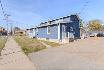 Schofield apartment for rent - A blue house with a porch and a driveway in front.