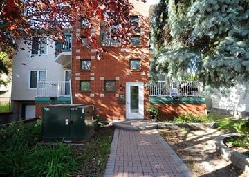 Ottawa apartment for rent - A red brick building with a white door and windows.