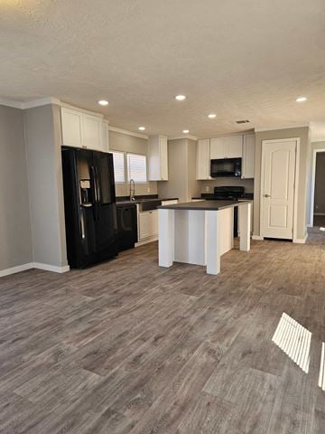 Guthrie house for rent - A kitchen with black appliances and wooden flooring.
