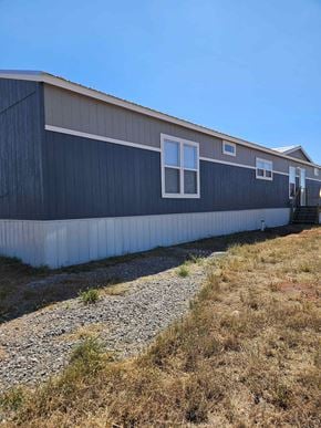 Guthrie house for rent - A long building with a grey roof and white trim.