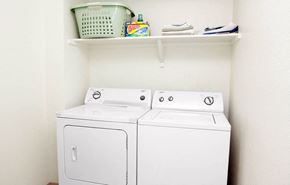 Lubbock apartment for rent - Two white front loading washing machines in a laundry room.