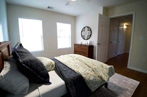 Lubbock apartment for rent - A bedroom with a bed, pillows, and a window.
