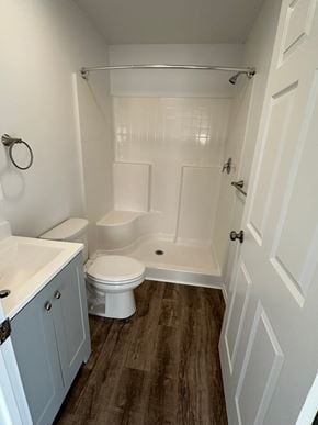 Granger apartment for rent - A white bathroom with a toilet, sink, and shower.