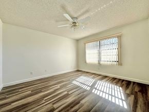 Bradenton house for rent - A room with wooden flooring and a ceiling fan.