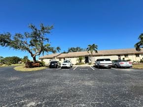 Bradenton house for rent - A parking lot with a building and cars in front of it.