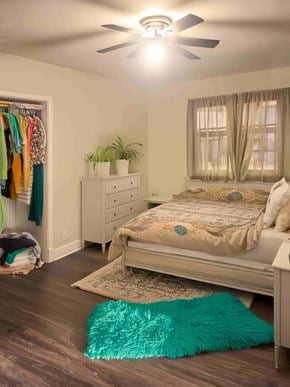 Winnipeg apartment for rent - A room with a bed, a dresser, a ceiling fan, and a rug.