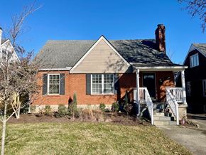 Louisville house for rent - A red brick house with a white porch.