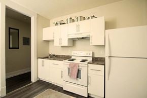 Winnipeg apartment for rent - A kitchen with white appliances and cabinets.