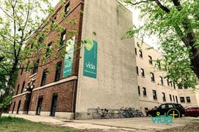 Winnipeg apartment for rent - A brick building with a banner that says "Vida" on it.