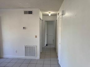 Orlando house for rent - A long hallway with a door at the end.