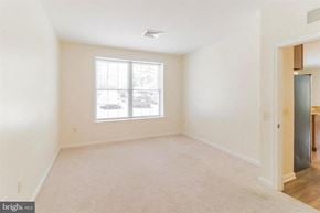 Phoenixville apartment for rent - A spacious room with a window and a door.