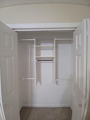 Clarksville house for rent - A white door is open to a small pantry with shelves.