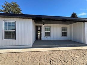 Grandview apartment for rent - A white building with a black roof and a door in the center.