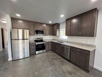Grandview apartment for rent - A kitchen with brown cabinets and a granite countertop.