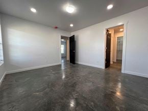 Grandview apartment for rent - A spacious room with a dark floor and white walls.