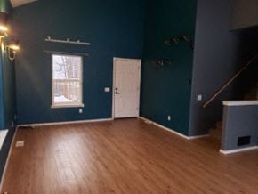 Anchorage house for rent - A room with a wooden floor and a white door.