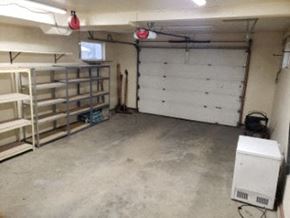 Anchorage house for rent - A white garage with a white door and a white cabinet.