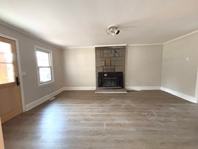 Piedmont house for rent - A room with a fireplace and a door.