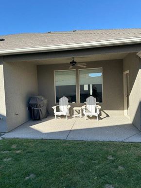 Pasco house for rent - Two white chairs are placed on a patio.