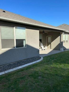 Pasco house for rent - A house with a patio and a lawn.