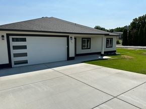 Benton City house for rent - A two-car garage with a white exterior and a black roof.