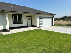 Benton City house for rent - A house with a garage and a green lawn.